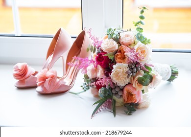 Wedding accessories for the morning of the bride in pink . Wedding bouquet and shoes of the bride.