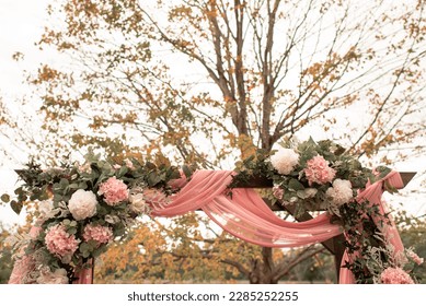 Wedding Arch or Arbor with Pink White Flowers and Pink Fabric - Powered by Shutterstock