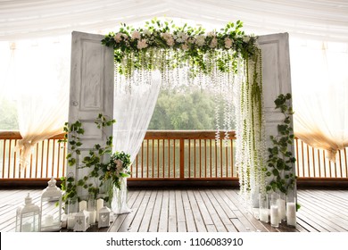 Wedding arch for wedding ceremony. Beautiful wedding decor in rustic style