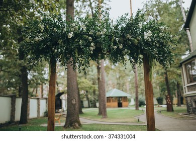 Wedding. Arch For The Ceremony. Flower Arrangements Of Flowers And Herbs Hanging On The Arch For The Wedding Ceremony