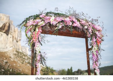 Wedding arch in the field. Wedding ceremony. Mountain.