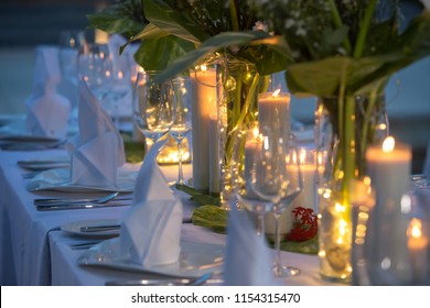 Wedding Banquet or gala dinner decorated with garlands. Festive table set up decor for wedding, party or event
