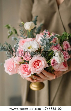 Similar – Woman decorated large bouquet of flowers with roses in vase