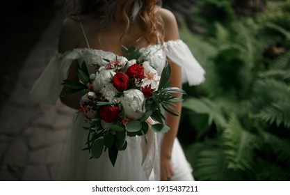 Wedding bouquet in the hands of the bride. 