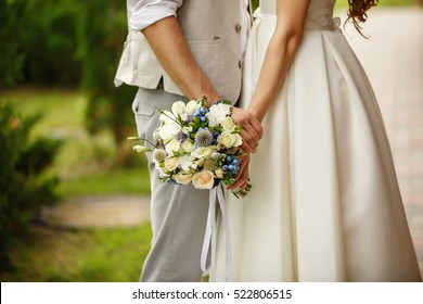 Wedding bouquet in hands of bride and groom in wedding day