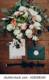 wedding bouquet and invitation. stylish modern flowers and floral invitation boutonniere and bow tie on wooden background top view. flat lay of rustic wedding  morning. space for text - Shutterstock ID 618268160