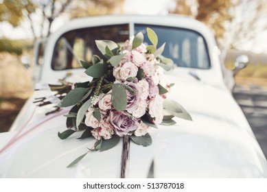 Wedding bouquet lies on the car. Wedding day. Summer Day