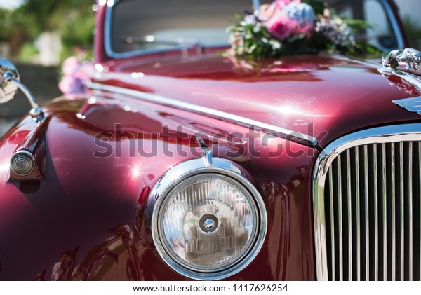 Wedding bouquet on red vintage wedding car.
Wedding decorations.