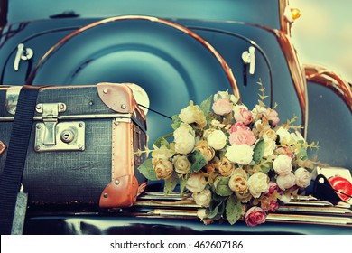 Wedding bouquet on vintage wedding car
