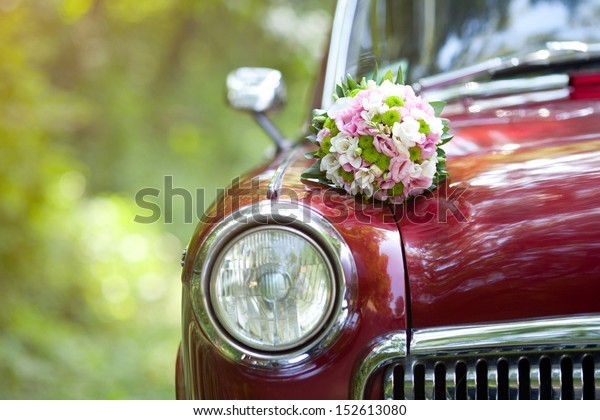 Wedding bouquet on vintage\
wedding car