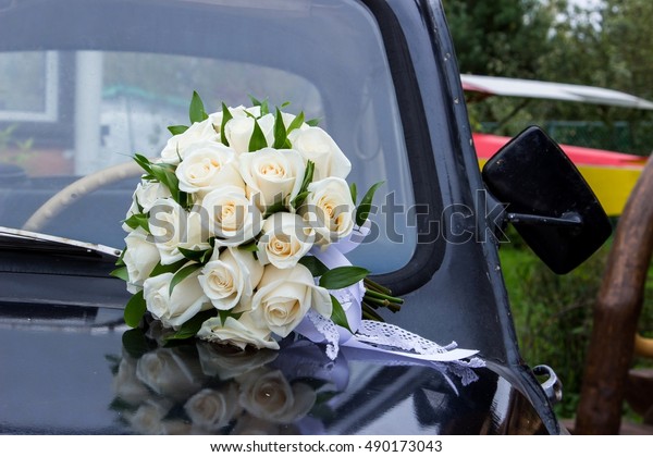 Wedding bouquet on vintage\
wedding car