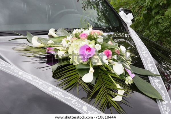 Wedding bouquet on\
vintage wedding car 