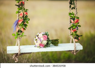 Wedding bouquet of peonies lying on a white bench swing decorated with fresh flowers. - Powered by Shutterstock