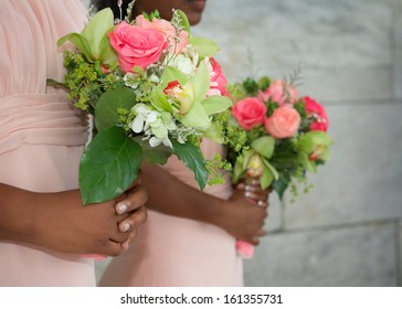 Wedding bouquets in hands of African American bridesmaids at ceremony - Powered by Shutterstock