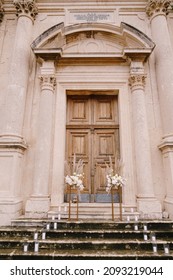 Wedding Bouquets Stand On Gold Plinths On The Stone Steps Of The Church