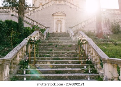 Wedding Bouquets Stand On Gold Pedestals On The Stone Steps Of An Ancient Church