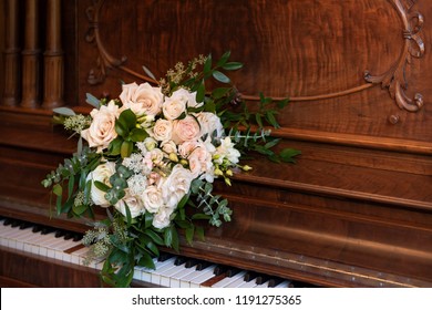 Wedding Bridal Bouqet On The Vintage Old Wooden Piano