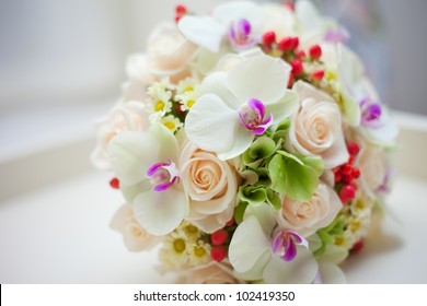 wedding bridal bouquet with white orchids, roses, daisies and red berries - Powered by Shutterstock