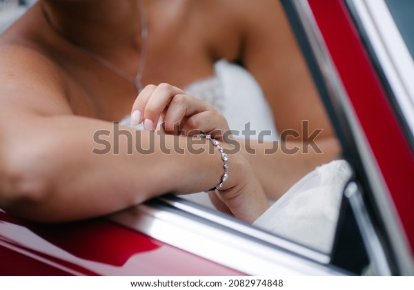 Wedding bride sit on red retro\
car passenger seat close up view after wedding honeymoon\
concept