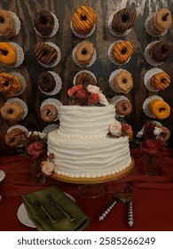 Wedding cake and donut wall dessert table. 