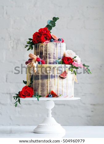 Wedding cake with flowers, figs, macarons and blueberries