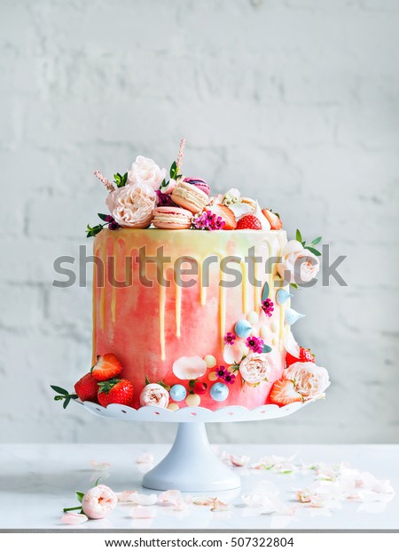 Wedding cake\
with flowers macarons and\
blueberries