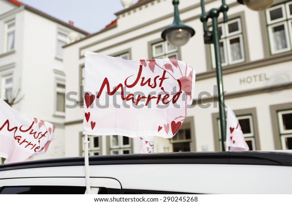 at a\
wedding car a banner with the text just\
married