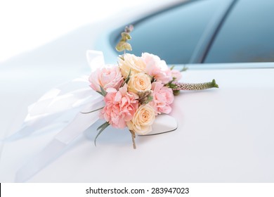 Wedding car with beautiful decorations of pink and orange roses