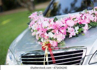 wedding car. Wedding decoration on wedding car. Luxury wedding car decorated with flowers. just married sign and cans attached.