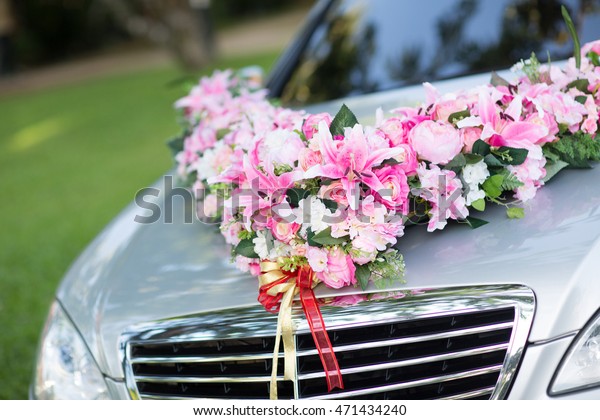 wedding car. Wedding decoration on wedding car.\
Luxury wedding car decorated with flowers. just married sign and\
cans attached.