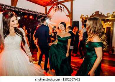 Wedding Celebration. The Bride And Her Friends Dance On The Dance Floor