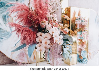 The wedding ceremony area is decorated with decorative panels and colorful flower arrangements