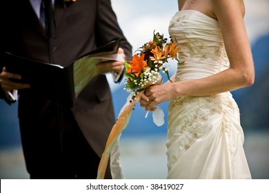 A Wedding Ceremony By The Lakeside With The Bride And The Minister