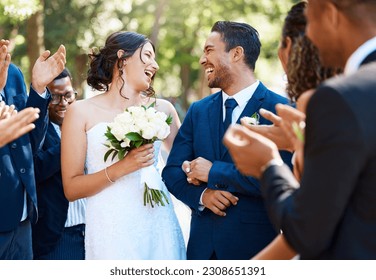 Wedding ceremony, couple and people clapping hands in celebration of love, romance and union. Happy, smile and bride with bouquet and groom walking by guests cheering for marriage at an outdoor event - Powered by Shutterstock