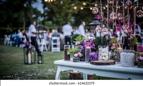 Wedding Ceremony with flowers outside in the garden with hanging lights - Shutterstock ID 614632379