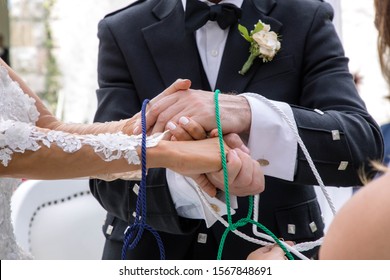 Wedding ceremony hands tied in nautical rope handfasting vows