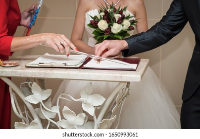 The Wedding Ceremony, The Master Of Ceremonies Indicates With A Pointer Where To Put The Signature. Legal Husband And Wife