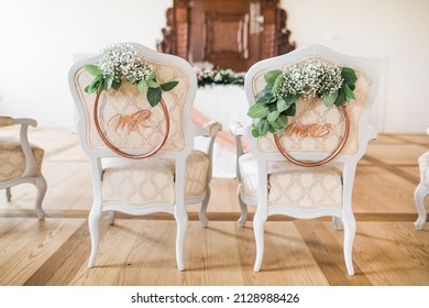 Wedding Ceremony Setup Chairs With Mr And Mrs Sign, Decorated With White Flowers, Luxury Indoor Venue With Natural Light