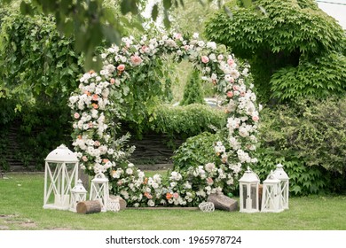 Wedding ceremony. Very beautiful and stylish wedding arch, decorated with various fresh flowers, standing in the garden. Wedding day. Fresh flowers decorations, Peony weddng.