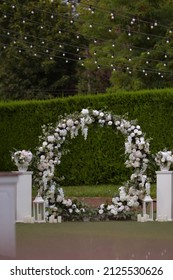 Wedding ceremony. Very beautiful and stylish roundwedding arch, decorated with various flowers, standing on the terrace. Wedding day.