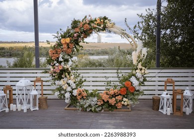 Wedding ceremony. Very beautiful and stylish wedding arch, decorated with various fresh flowers and pampas grass, standing outside. Wedding day. Fresh flowers decorations. - Powered by Shutterstock