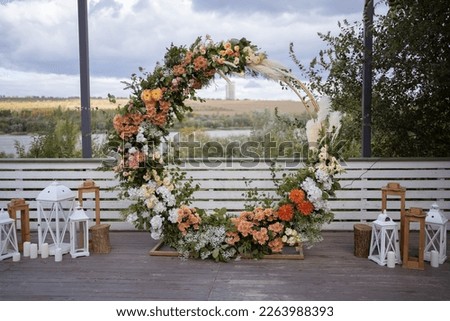 Wedding ceremony. Very beautiful and stylish wedding arch, decorated with various fresh flowers and pampas grass, standing outside. Wedding day. Fresh flowers decorations.