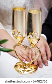 Wedding Champagne Glasses And Bride And Groom Hands With Rings
