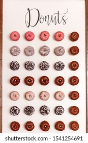 Wedding Chocolate Donuts For Guests. Festive Concept. Sweets On A Wedding Day. Wedding Donuts. A Yummy Donut Wall.