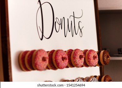 Wedding Chocolate Donuts For Guests. Festive Concept. Sweets On A Wedding Day. Wedding Donuts. A Yummy Donut Wall.