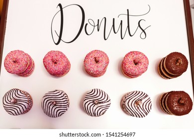 Wedding Chocolate Donuts For Guests. Festive Concept. Sweets On A Wedding Day. Wedding Donuts. A Yummy Donut Wall.