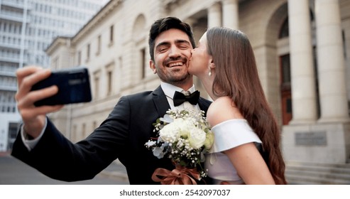 Wedding, city and selfie with kiss on street at courthouse with bride, love and bouquet for celebration. Social media, profile picture and marriage event for commitment, loyalty and trust together - Powered by Shutterstock