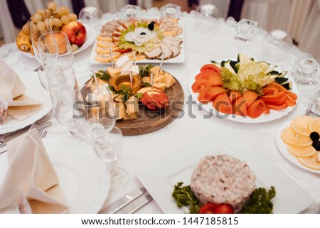 Wedding concept. Catering table set service with silverware and glass stemware at restaurant before party.