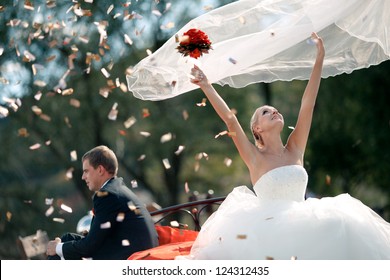 Wedding couple bride and groom in nature. The bride throws up veil. - Powered by Shutterstock