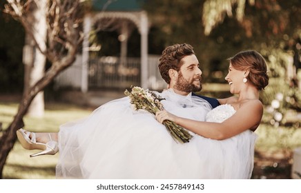 Wedding, couple and carrying woman in nature for love, protection and commitment at venue for celebration. Lifting bride, man and happy in garden for marriage, partnership and support with flowers - Powered by Shutterstock